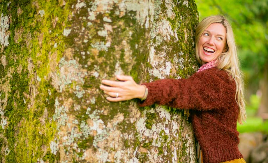 tree hugging woman